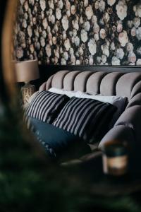 a bed with black and white pillows in a room at Cottage 3 Bed Sleeps 7 Free Parking in Enniskillen