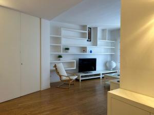 a living room with white shelves and a television at Piccinni Exclusive Suite 182 in Bari