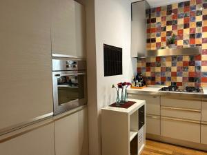 a kitchen with a vase of flowers on a counter at Piccinni Exclusive Suite 182 in Bari