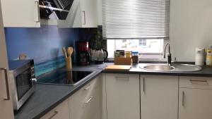 a kitchen with white cabinets and a sink and a window at Unseburg-Brauhaus GmbH,Family,FW 6 in Unseburg