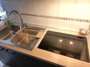 a kitchen sink with a strainer next to a sink at Casa vacanze Casa Elena in San Giorgio a Cremano +15 photos