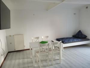 a room with a table and chairs and a bed at Unseburg-Brauhaus GmbH,Family,FW 6 in Unseburg