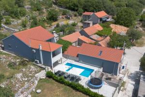 an aerial view of a house with a swimming pool at Nany-Villa with heated pool in Trolokve