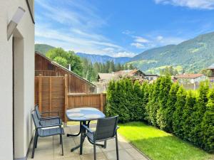 a patio with a table and chairs on a balcony at Apartments ALPsmart in Oetz