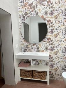 a bathroom with a white sink and a mirror at B&B I versi del mare in Roseto degli Abruzzi