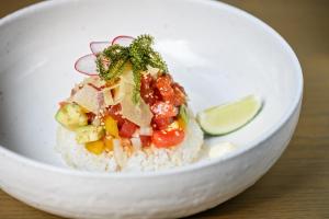 a white bowl with rice and vegetables and a lime at Glamday Style Okinawa Yomitan Hotel & Resort in Yomitan