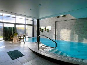 a large swimming pool in a building at Panorama View in Jalovec