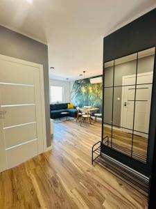 a living room with a large glass door and a table at Apartamenty Dębowa 27 in Milicz