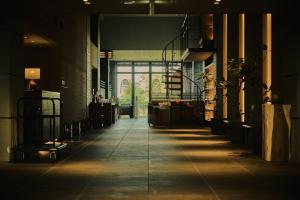 a hallway of a building with a light shining on the floor at Glamday Style Okinawa Yomitan Hotel & Resort in Yomitan