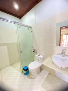 a bathroom with a shower and a toilet and a sink at Luangprabang Villa Kee Lee in Luang Prabang +42 photos