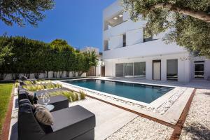 a swimming pool in the backyard of a house at Infinity White Complex by GK Hospitality Group in Porto Rafti