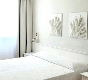 Postel nebo postele na pokoji v ubytování Hotel Acquamarina