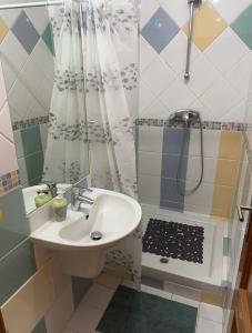 a bathroom with a sink and a shower at Montenegro Dreams in Faro +36 photos