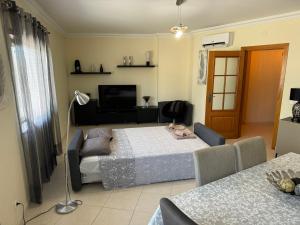 a living room with a bed and a couch at Montenegro Dreams in Faro