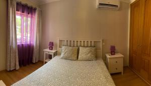a bedroom with a bed with two night stands and two lamps at Montenegro Dreams in Faro