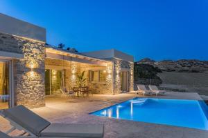 a villa with a swimming pool in front of a house at Villa Vidan in Matala by South Cretan Villas in Matala