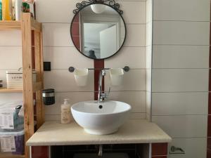 a bathroom with a white sink and a mirror at colored houses in Ierapetra +60 photos