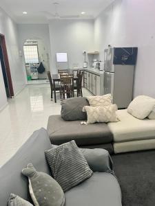 a living room with two beds and a kitchen at Aqua Shelter in Mersing