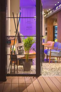 a room with a table with a plant in it at Apt with best rated breakfast ZAP B&B in Split