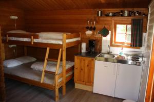 a kitchen with two bunk beds and a sink at Buøy Camping in Dalen +43 photos