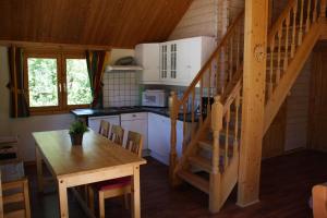 a kitchen with a table and a staircase in a cabin at Buøy Camping in Dalen