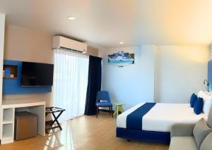a hotel room with a bed and a couch at Days Inn by Wyndham Patong Beach in Patong Beach