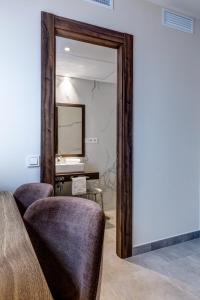a mirror in a room with two chairs and a desk at Hotel La Florida in Seville +5 photos