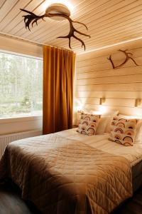Un pat sau paturi într-o cameră la Aito Igloo & Spa Resort