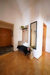a living room with a piano and a mirror at Apartments Loncar-near Zrće beach in Novalja