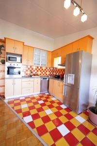 a kitchen with a checkered floor and a refrigerator at Apartments Loncar-near Zrće beach in Novalja