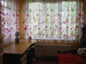 a room with curtains with butterflies on them at Skaistie Majori in Jūrmala