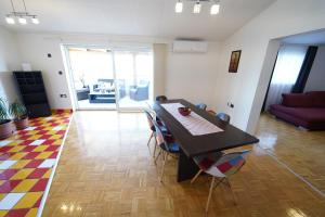a dining room with a table and chairs in a living room at Apartments Loncar-near Zrće beach in Novalja
