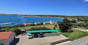 a blue gas station with a view of the water at Apartments Loncar-near Zrće beach in Novalja