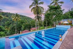 a swimming pool with a view of a mountain at Athulya Villas, Kandy in Kadugannawa