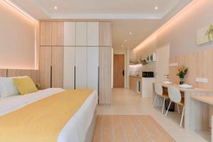 a bedroom with a large bed and a kitchen at Riverine Diamond Kuching in Kuching