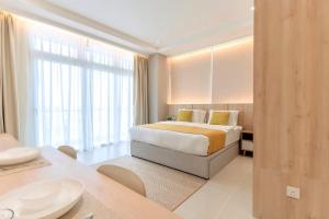 a hotel room with a bed and a large window at Riverine Diamond Kuching in Kuching