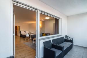 a living room with a window and a couch at Am Hochwald mit Burgblick in Bad Liebenzell
