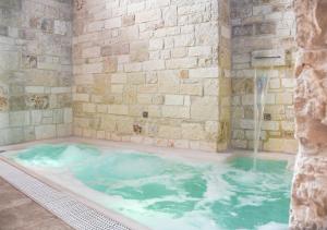 a jacuzzi tub with a water fountain at Trulli e Puglia Luxury Suite in Alberobello