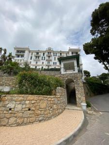 a building on top of a stone wall with a building at Magico Relax Bordighera-Open space con piscina e vista mare in Bordighera