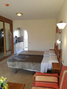 a bedroom with a large bed and a kitchen at Costa del Silencio Studio in Costa Del Silencio