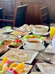 a table with plates of food and a cup of coffee at Crowne Plaza Danang Hotel & Resort in Da Nang