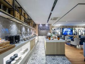 a restaurant with a counter in a room at Echarm Hotel Nanning the MixC Exhibition Center Metro Station in Nanning