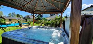 a hot tub in a backyard with an umbrella at Fewo Traum in Neppermin