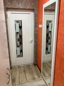 a hallway with two mirrors in a room at Apartman Slavica 2 in Nova Varoš