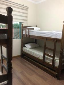 two bunk beds in a room with a window at Hostel 2 Martina SPExpo 100m in Sao Paulo