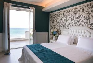 Postel nebo postele na pokoji v ubytování Bianco Riccio Suite Hotel