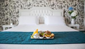 Postel nebo postele na pokoji v ubytování Bianco Riccio Suite Hotel