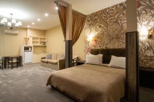 a bedroom with a bed and a living room at Shato Luxe in Odesa