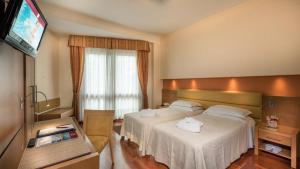 Postel nebo postele na pokoji v ubytování Hotel Terme Antoniano