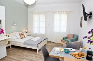 a bedroom with a bed and a dining room at Skalopati Studios & Villa in Panormos Skopelos
